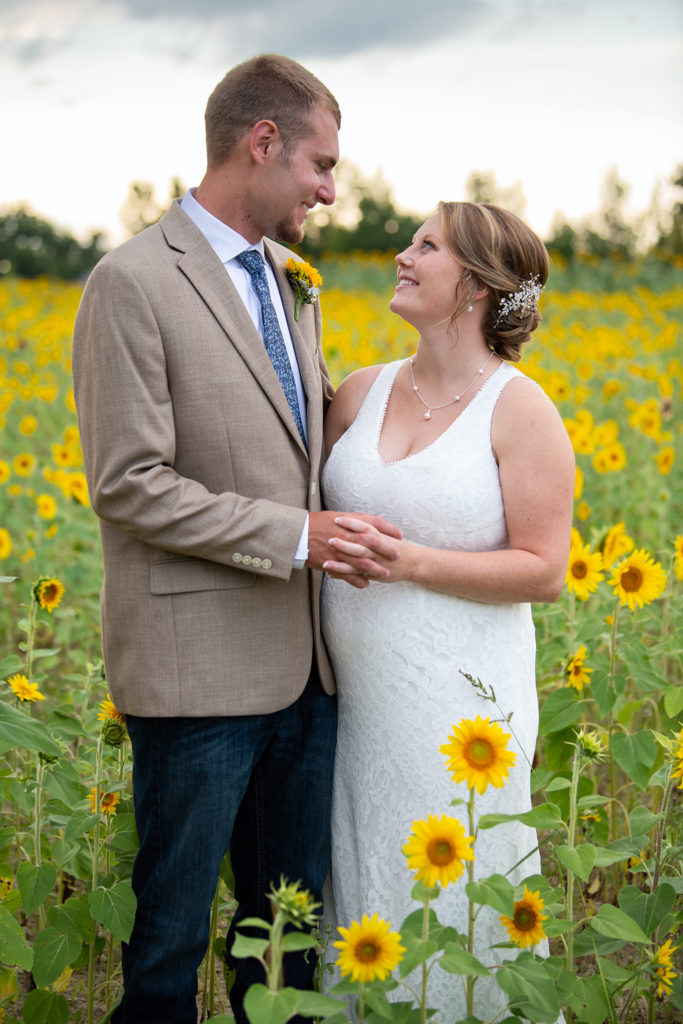Bride and groom in sunflower field