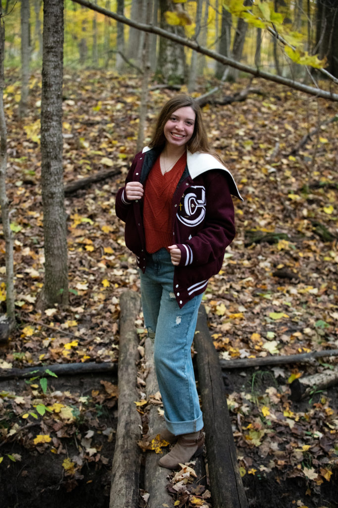 Fall senior portrait on wooded trail
